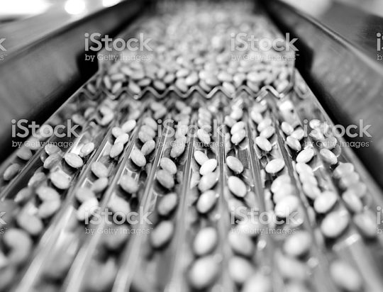 Close-up of the red pill in production line.